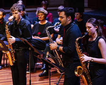 Students boys and girls playing the saxophone