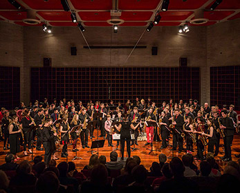 Saxophone orchestra playing in a live concert.